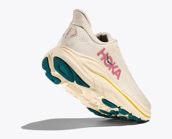 HOKA moving footwear with cushioned sole and teal accents, shown from a broadside angle, perfect for showcasing comfortableness and enactment for progressive wear