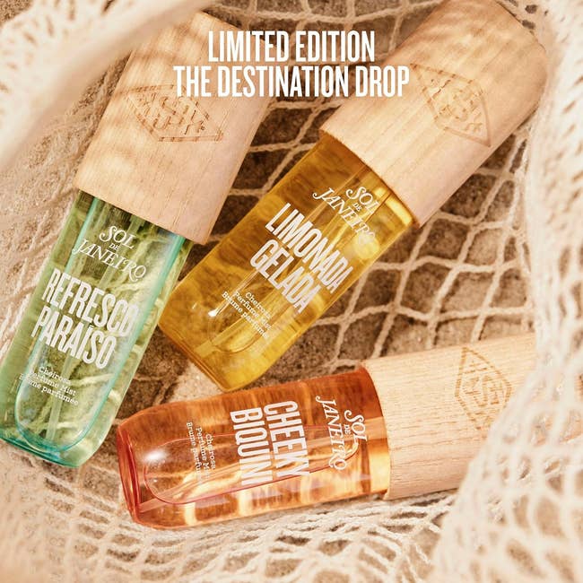 Three Sol de Janeiro fragrance mists named Refresco Paraiso, Limonada Gelada, and Cheer Bloom are displayed successful a nett bag
