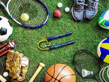 glovestix laying on grass surrounded by various sports equipment