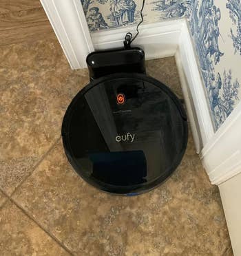 Reviewer's robot vacuum in docking station