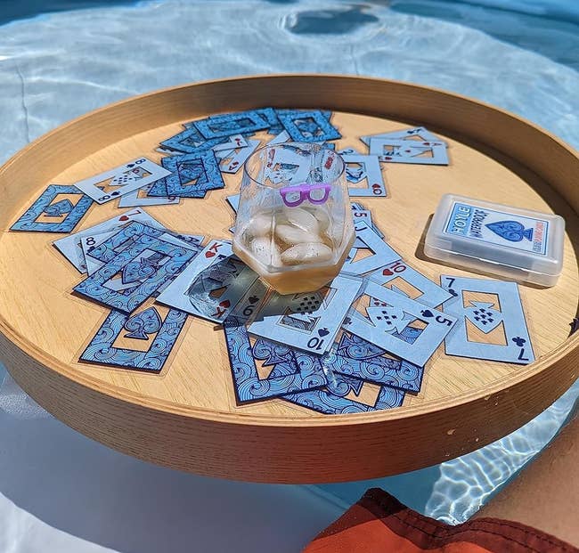 Playing cards connected a tray successful the pool