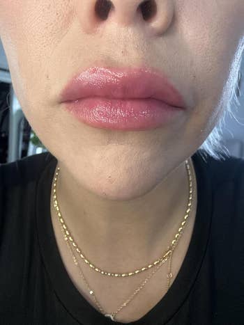 Close-up of a reviewer's lips with glossy lipstick