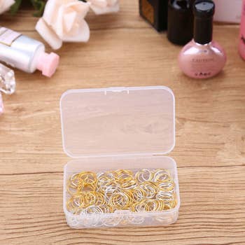 lifestyle image of the box of gold and silver hair rings