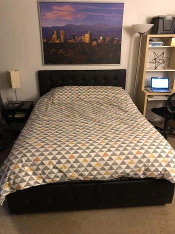 reviewer showing the bed in black