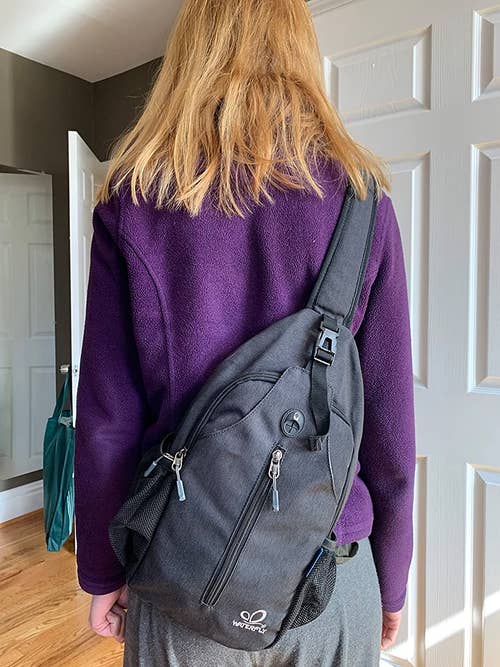A reviewer wearing the sling in gray 