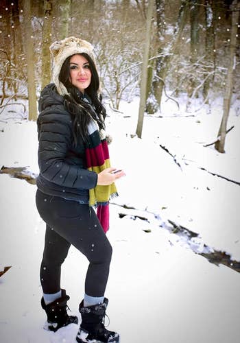 Reviewer hiking in the snow in black leggings 