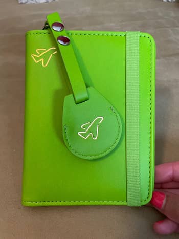 passport holder closed wit airtag chained onto it