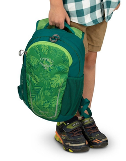 a child model holding a leaf-printed backpack