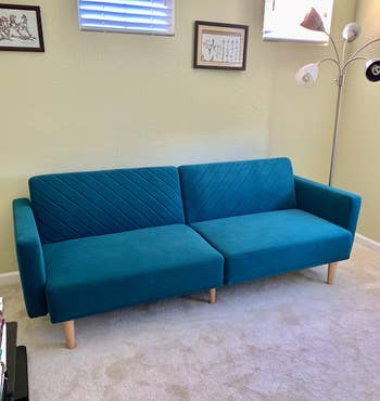 reviewer photo of the blue couch in an upright position