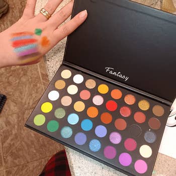 reviewer holding palette open with swatched of colors on hand