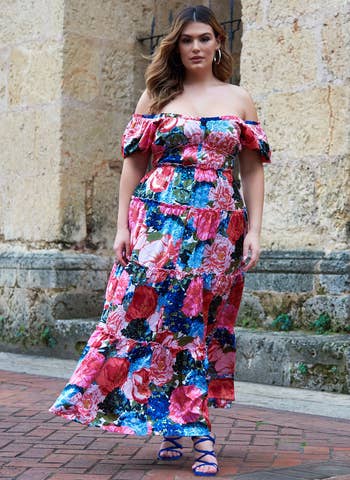 model in off the shoulder pink red and blue floral maxi dress