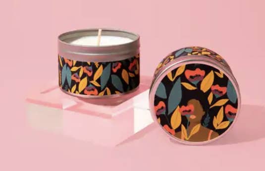 candle in floral print tin with lid featuring a person's silhouette