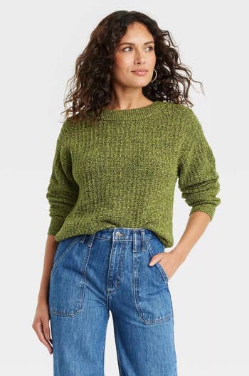 model wearing a green pullover sweater