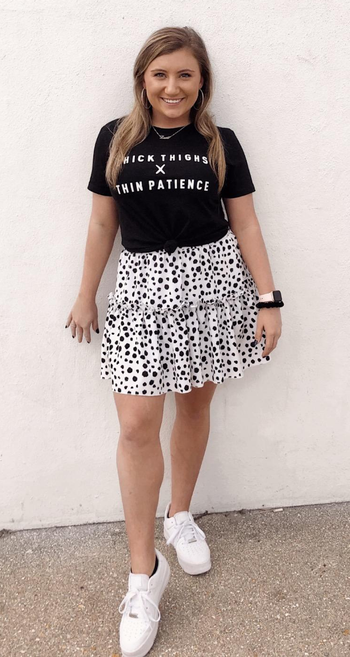 Reviewer wearing black and white skirt