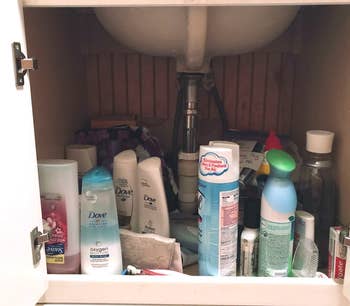 reviewer's under-sink cabinet before without shelf kit