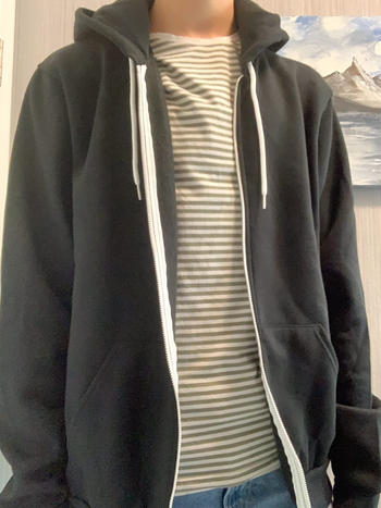 reviewer wearing the hoodie in grey