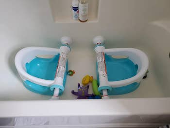 reviewer's photo of two bath seats installed in a bath tub