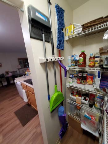 another reviewer's broom holder in a pantry