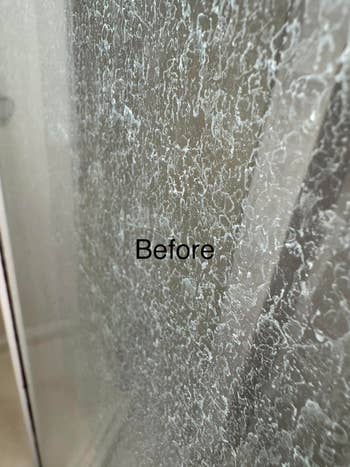 Close-up of a glass surface with hard water stains. The word