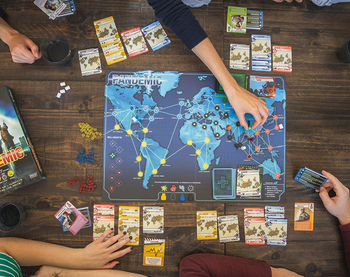 a top-down view of the game board and cards set up around it 