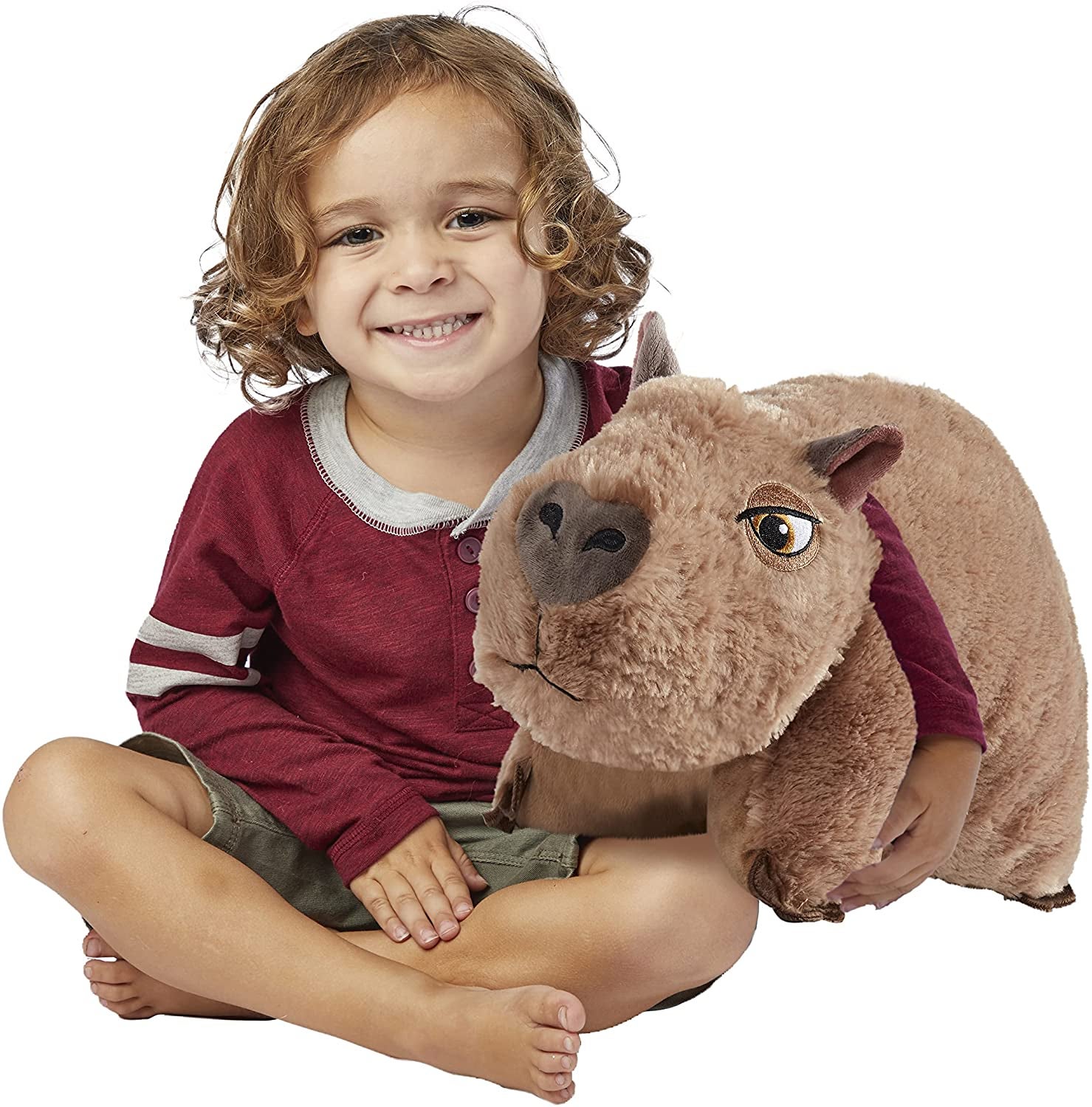 a child cuddling with the capybara pillow pet