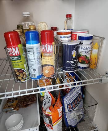 Pantry shelf with various cooking sprays, spices, and food items for home cooking