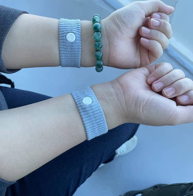 reviewer wearing the gray sea bands on both wrists