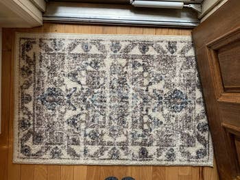 Reviewer image of the rug in front of a door