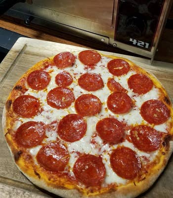 reviewer photo of pepperoni pizza made using the pizza oven
