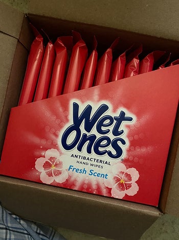 Reviewer's box of travel-sized packs of Wet Ones