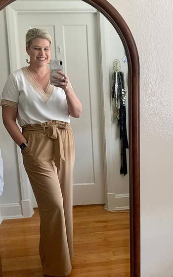 a reviewer wearing the pants in solid tan 