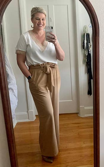 a reviewer wearing the pants in solid tan 
