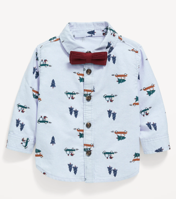 a light blue collared button down with a design of a tree and cars driving presents on it and a burgundy bow tie