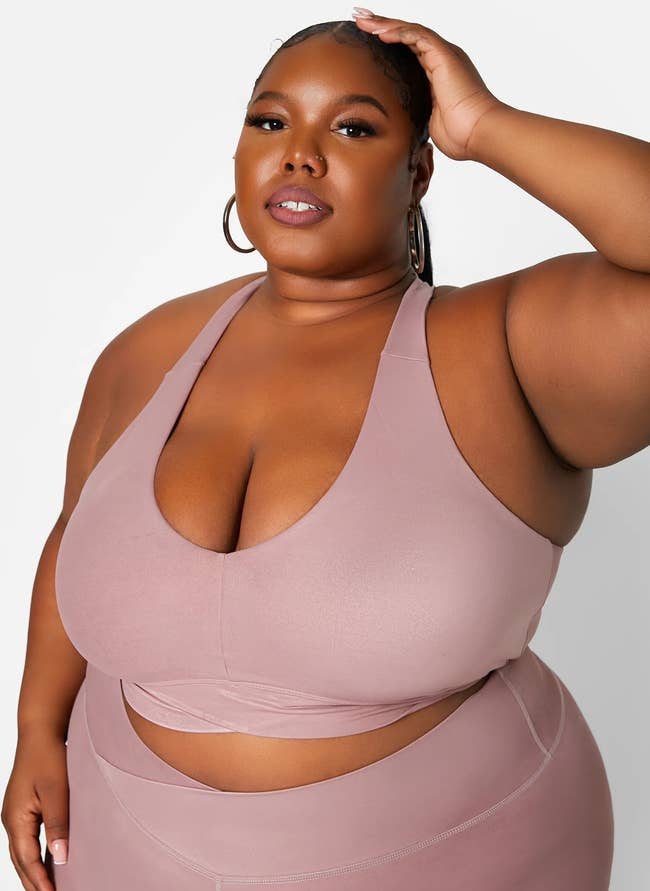 model wearing the V-neck sports bra in mauve with matching leggings