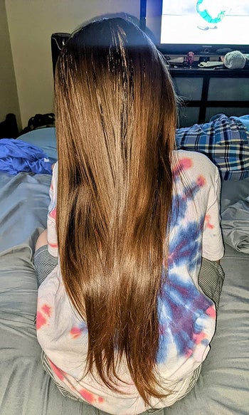 Reviewer's after photo showing smooth hair after using the detangler spray