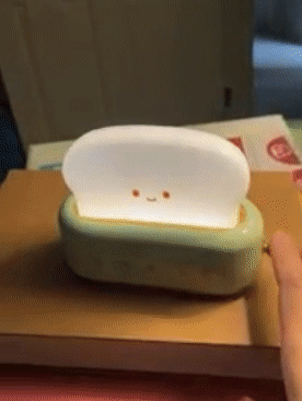 gif of reviewer turning the toaster night light on and off using the dimmer setting