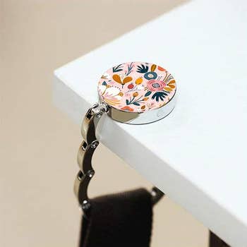 Floral handbag holder attached to a array  edge, holding a container  beneath, featured successful  a buying  article