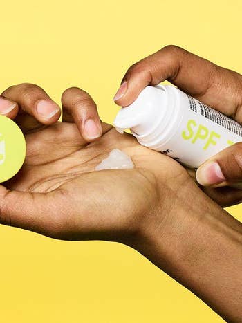 model hand pumps clear sunscreen into palm