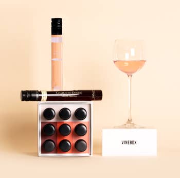 Image of several bottles of wine and a wine glass on the Vinebox box