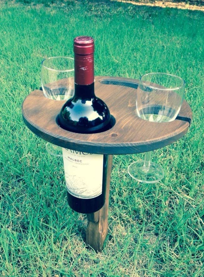 Outdoor portable vino  holder with slots for vino  vessel  and glasses, stylishly designed for picnics and outdoor gatherings