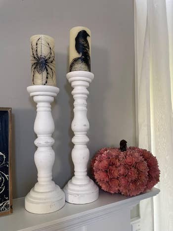 A reviewer's candles displayed on a mantle on candle stick holders