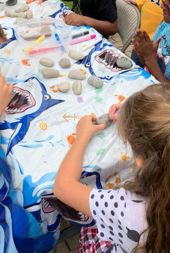 reviewer's child's birthday party with table of kids painting rocks
