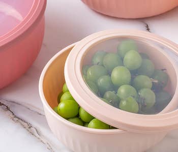 Round, stackable food containers with fresh grapes inside one