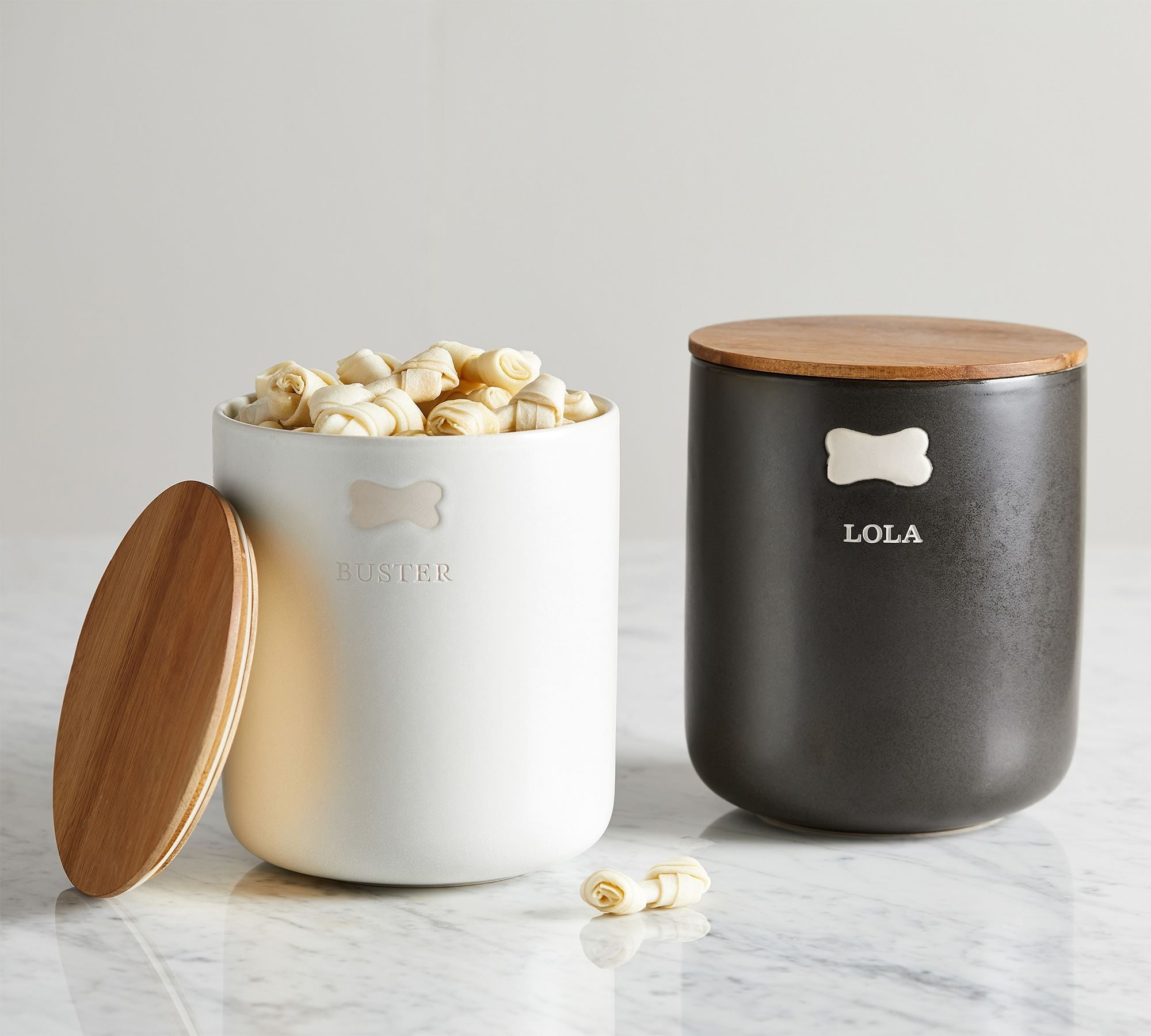 One black and one white canister with pet names monogrammed.