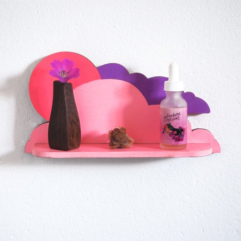 the pink and purple wood shelf shaped like clouds and the sun