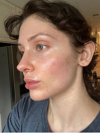 reviewer wearing the sunscreen with dewy skin