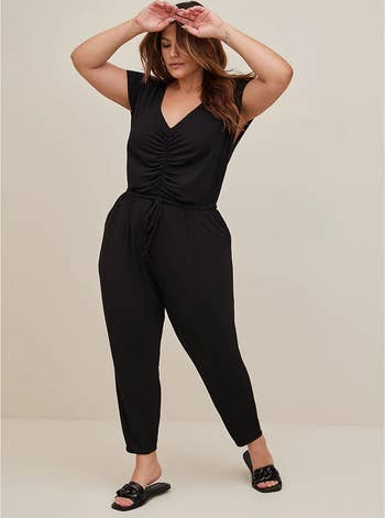 model wearing the black jumpsuit with black sandals