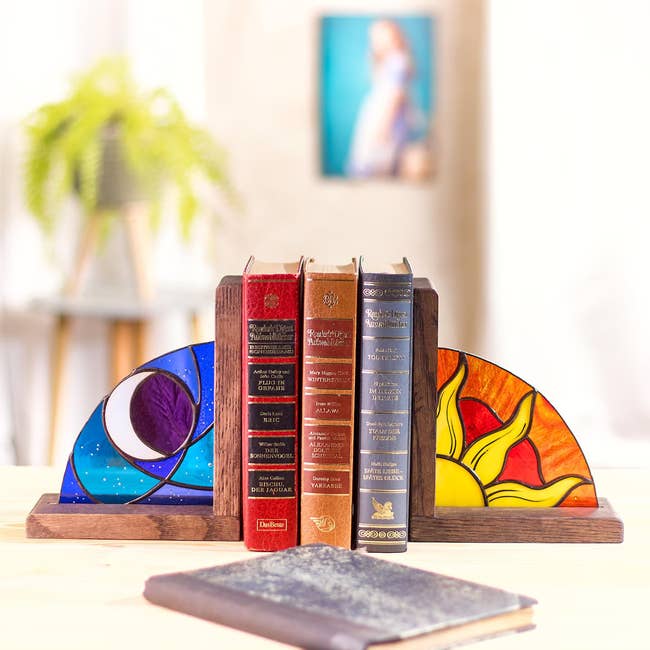 Stained glass bookends with moon and sun designs in wooden bases