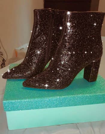 another reviewer's black rhinestone boots on top of a box