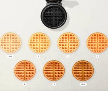 Waffle iron above seven waffles with varied toasting from 'min' to 'max'